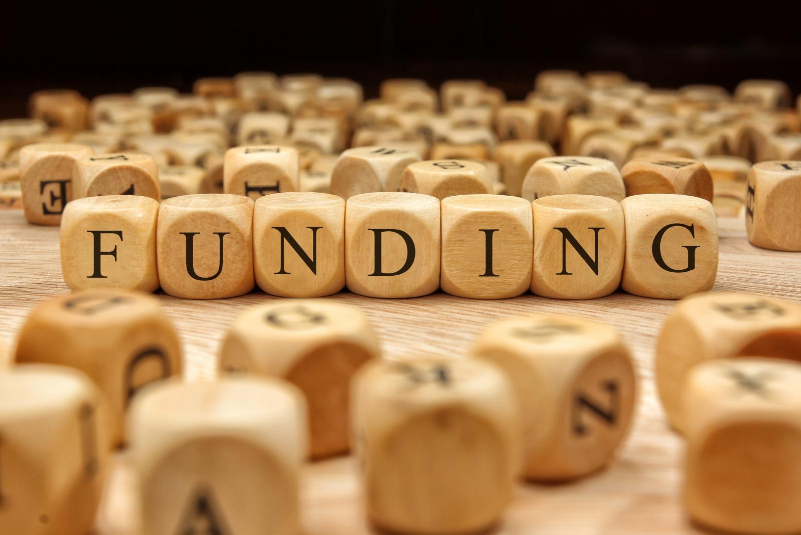 wooden blocks spelling funding