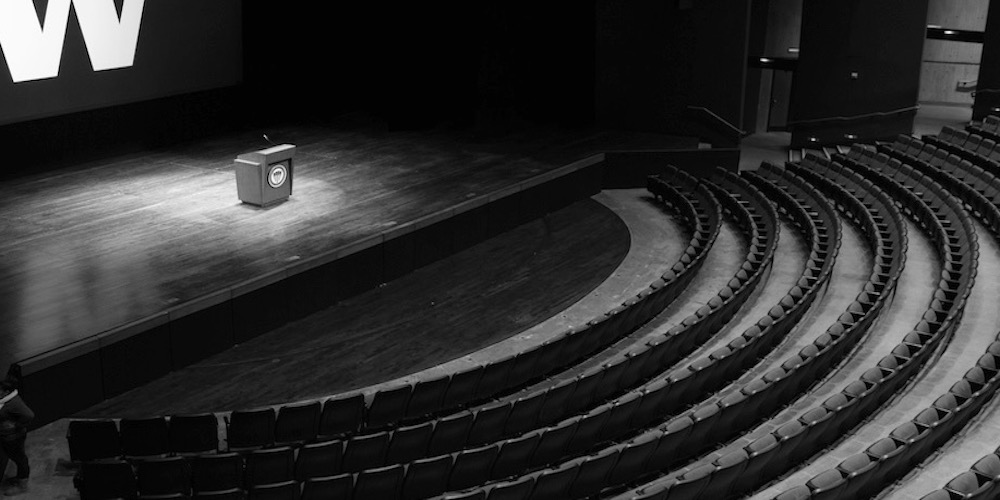 black and white birds eye image of an empty auditorium