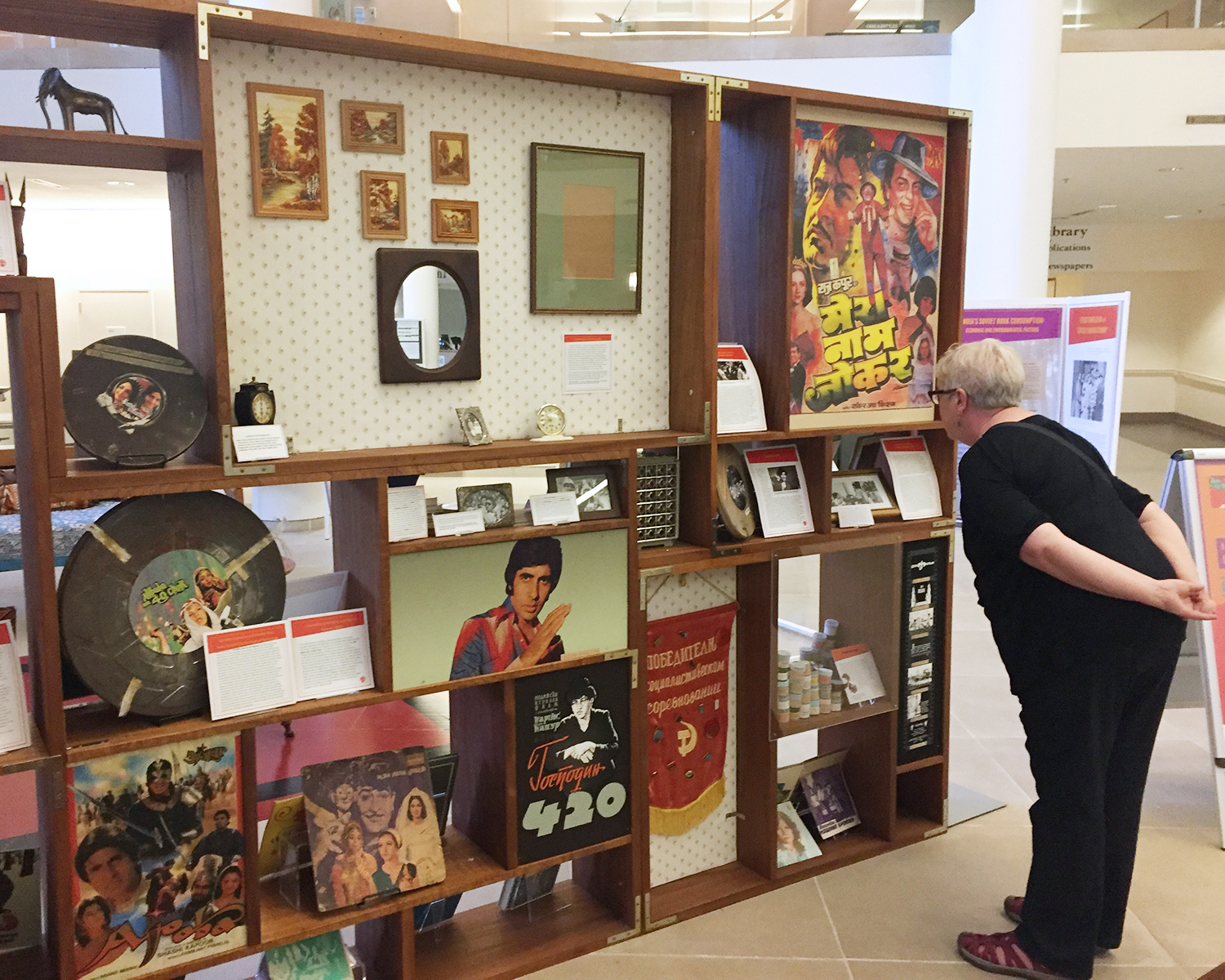 A viewer examines a movie poster and other ephemera included in the exhibit. Indian films made their popular debut in Soviet cinema halls during the 1954 Indian Film Festival. Tired of Stalin-era Socialist Realism, Soviet viewers gravitated toward Indian cinema to escape from the realities of everyday life. 