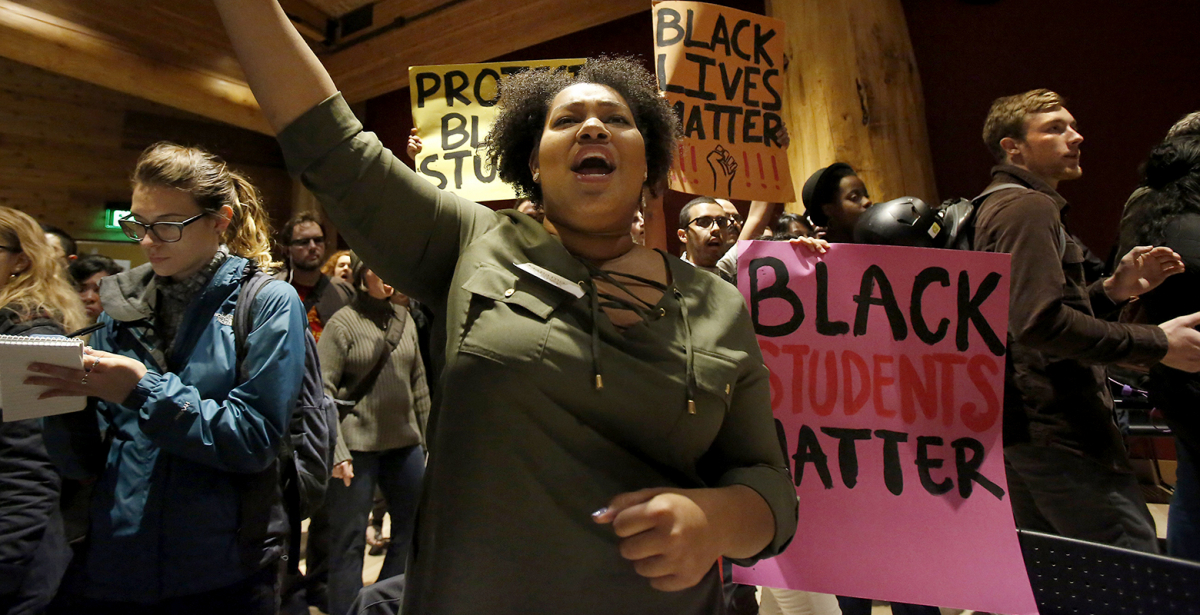 Protesters hold signs that read Black Students Matter and Black Lives Matter.