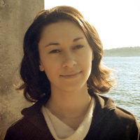 Photo of Rachel Arteaga standing in front of a body of water.