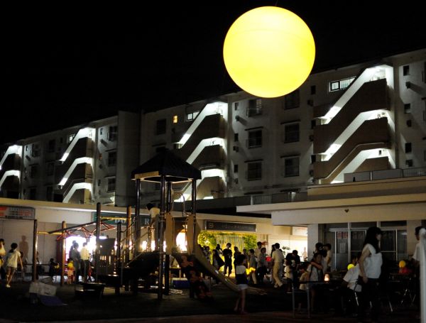 Guests and neighbors beneath the night sun at "Sun Self Hotel." Courtesy of Toride Art Project.
