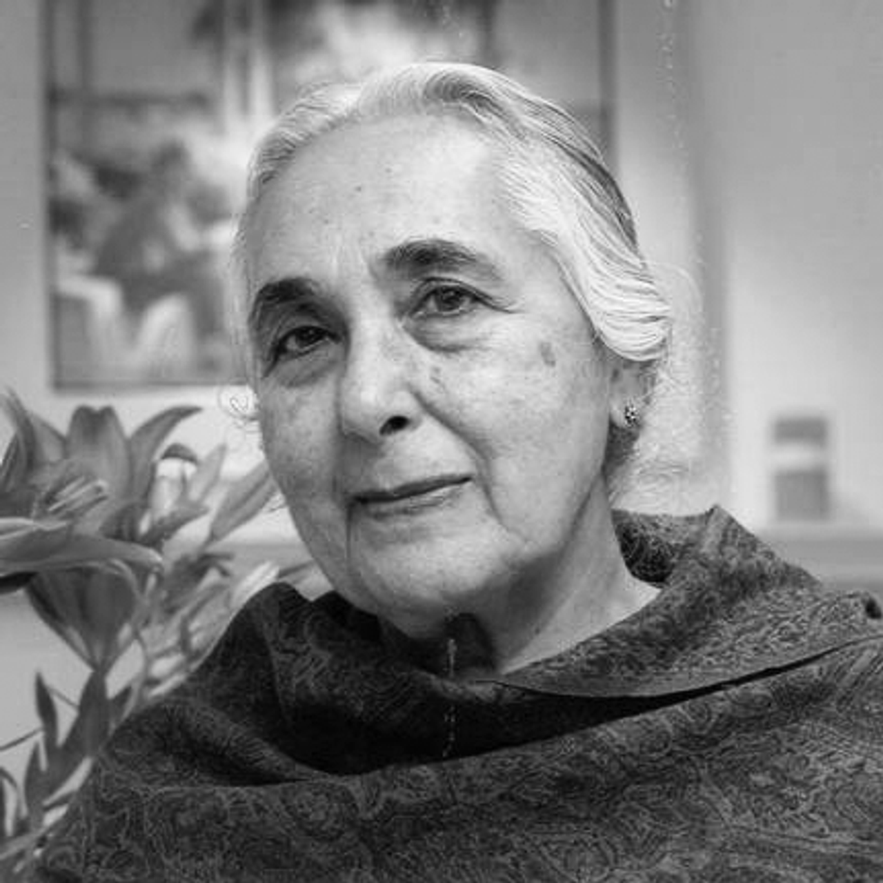 Black and white image of Romila Thapar looking into the camera.