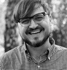 A black and white image of Darren Byler wearing glasses.