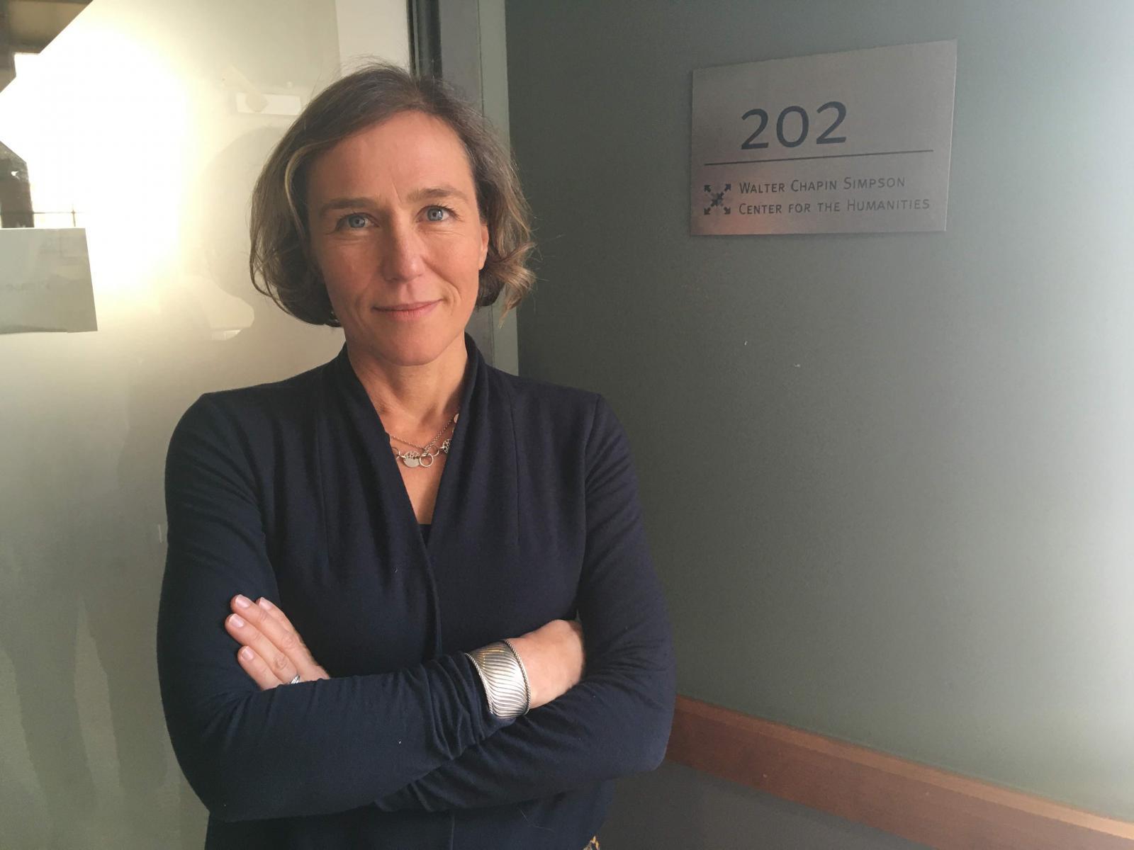 Professor Amelia Glaser standing outside the Simpson Center seminar room