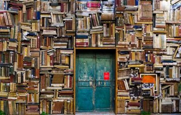 green door surrounded by books