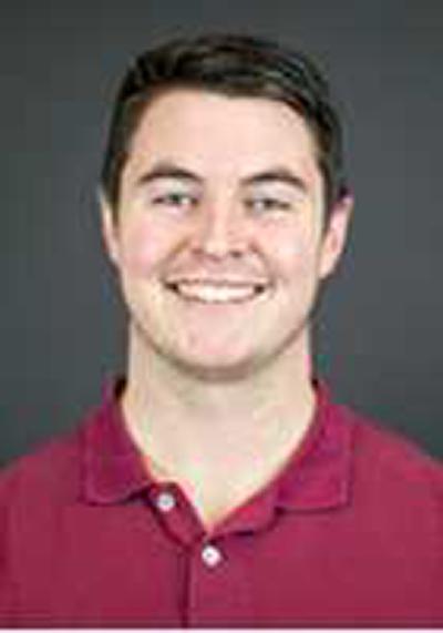 A close-up image of Kyle Kubler wearing a red shirt against a grey background.
