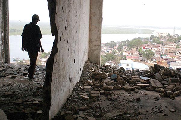 A figure stands in the ruined E.J. Roye Building in Monrovia, Liberia, in 2012. All photos courtesy Danny Hoffman.