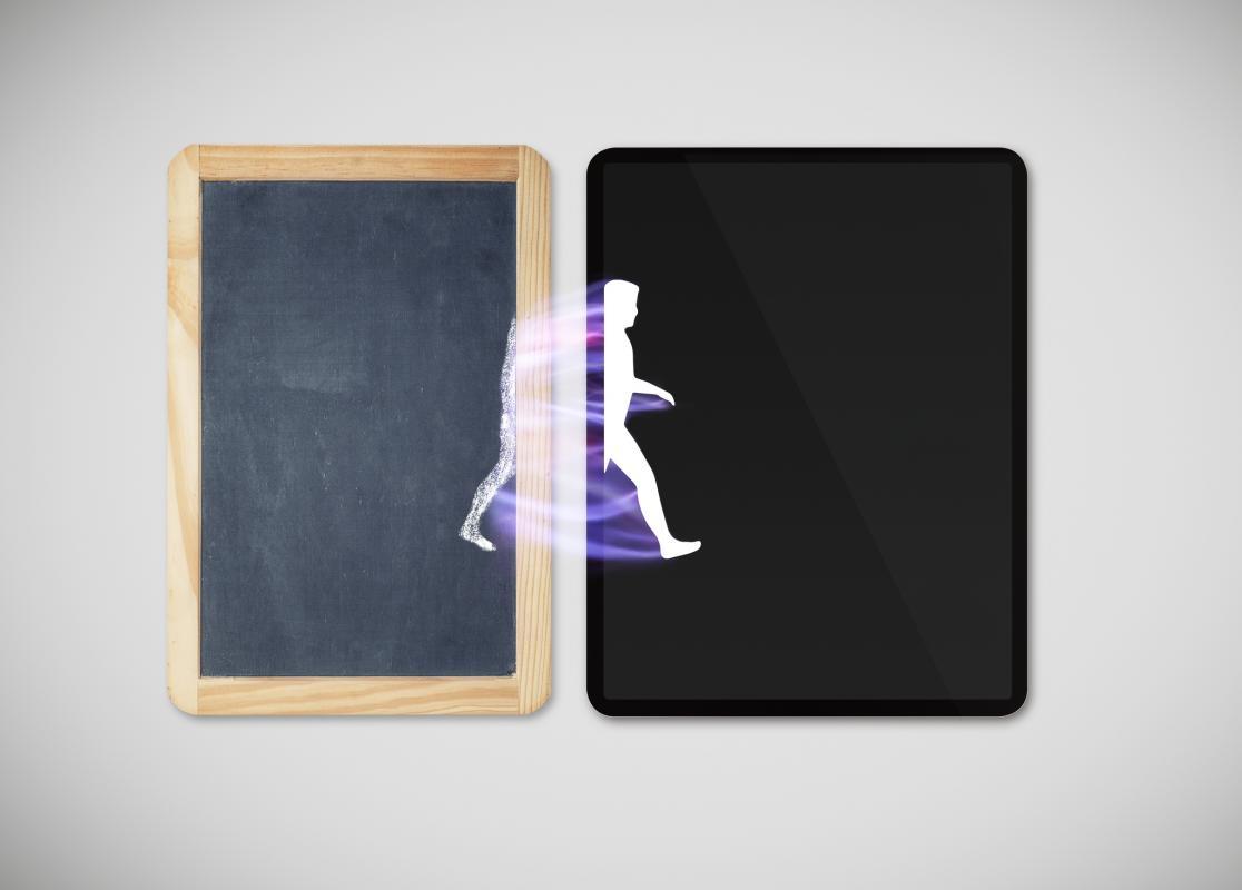 The silhouette of a person walks from a chalkboard onto an electronic tablet