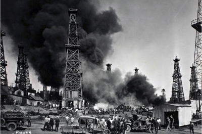  Crowds watching oil fields accident, smoke coming out of oil rigs. Circa 1920