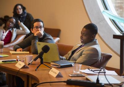 Activist poetics panel at a roundtable with microphones