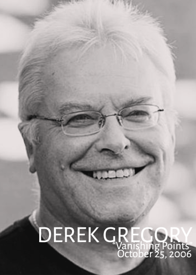 Black and white image of Derek Gregory wearing glasses.