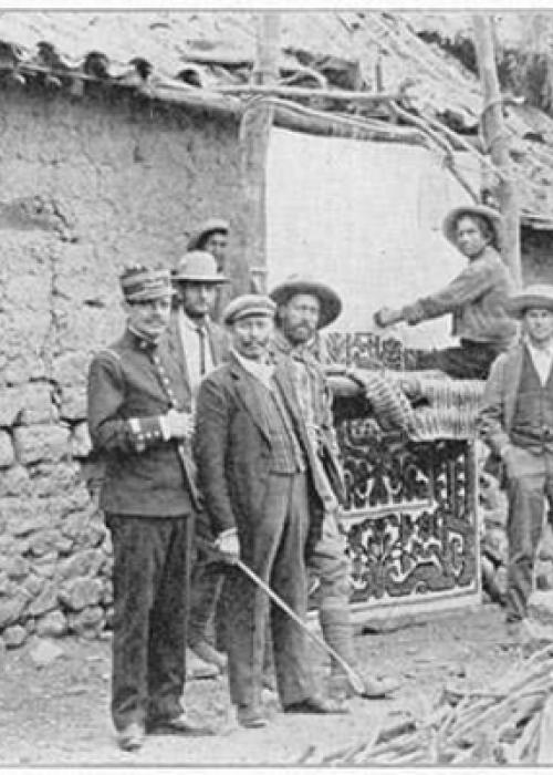 Old black and white photograph from the Yale Peruvian Expedition of people standing in front of a building