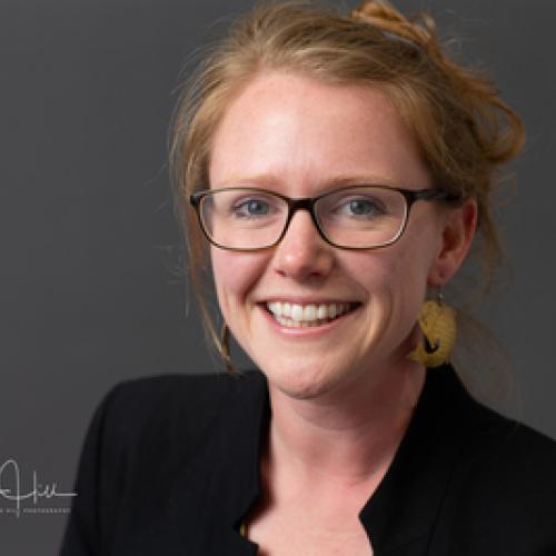 Sarah Inman professional photo in a black blazer smiling at the camera