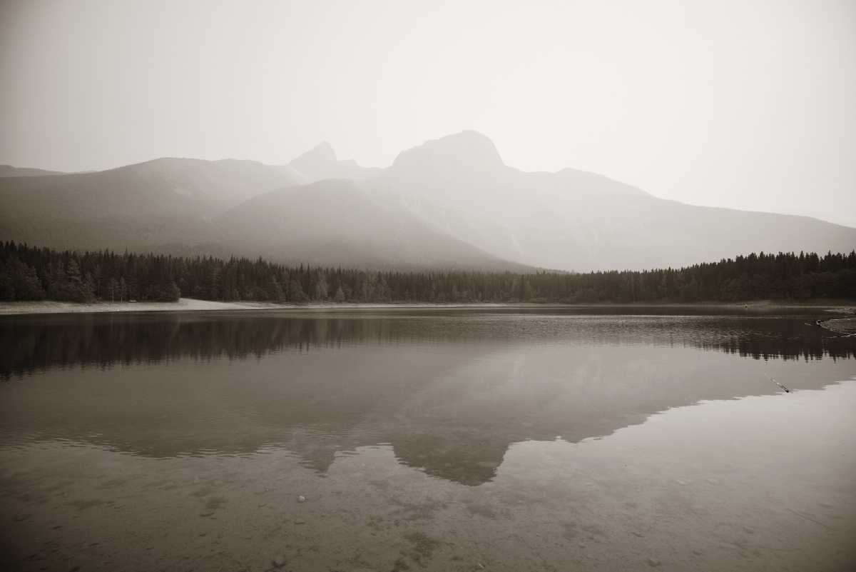 Reflection of trees and a mountain in lake