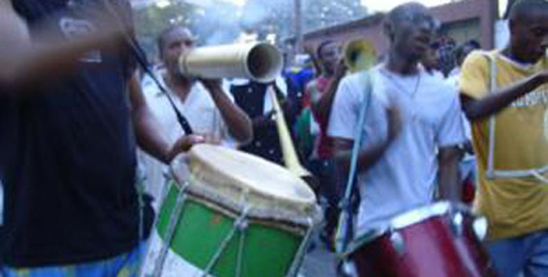 People playing drums and instruments in the streets of a Caribbean city