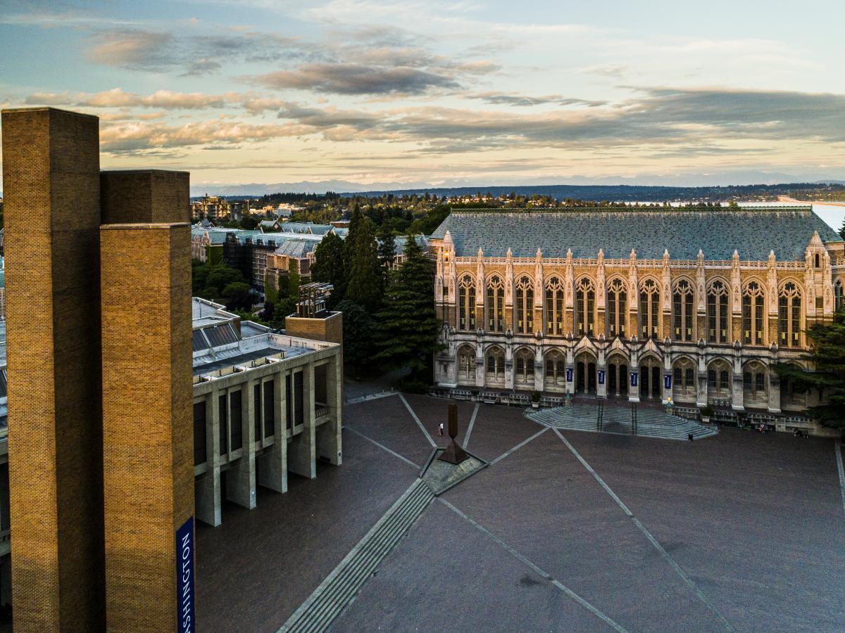 birds-eye view of the Suzallo and Allen Libraries with the brick-laid quad in the middle. It is a sunny day morning with light clouds in the sky.
