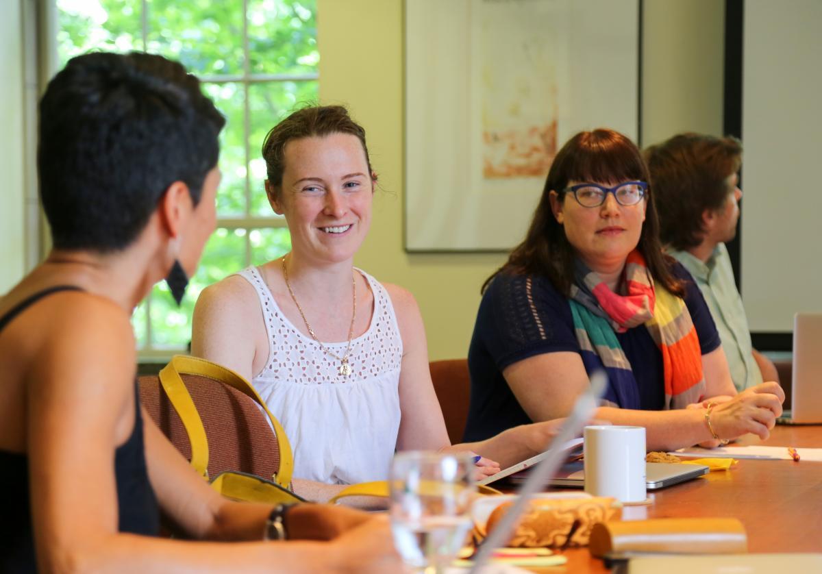 scholars in the fellowship program having a lively discussion at the conference table