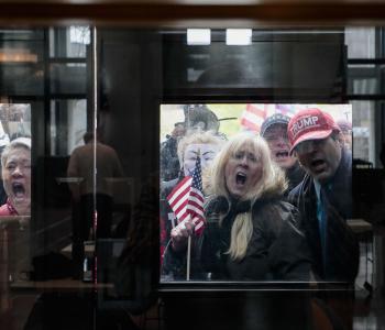 Crowd of anti-social-distancing protesters in Ohio yelling behind closed glass doors