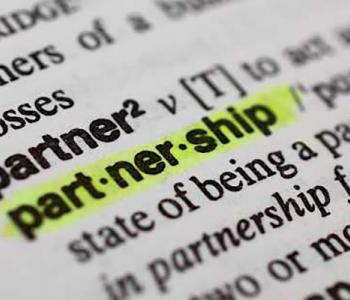 A close-up of the dictionary entry for "partnership," highlighted