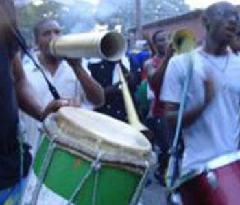 People playing drums and instruments in the streets of a Caribbean city