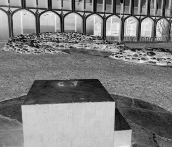 An inverted black and white image of "Blocked Out," a monument on the University of Washington Seattle campus.